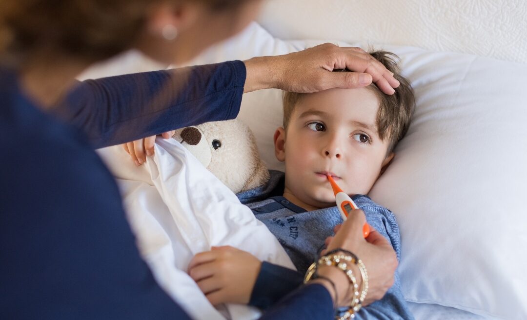 A sick child with a thermometer showing symptoms of Yellow Fever, appearing fatigued and unwell