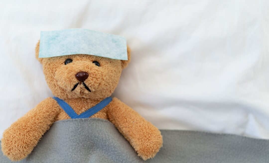 A Picture of a teddy bear who is sick of the flu.