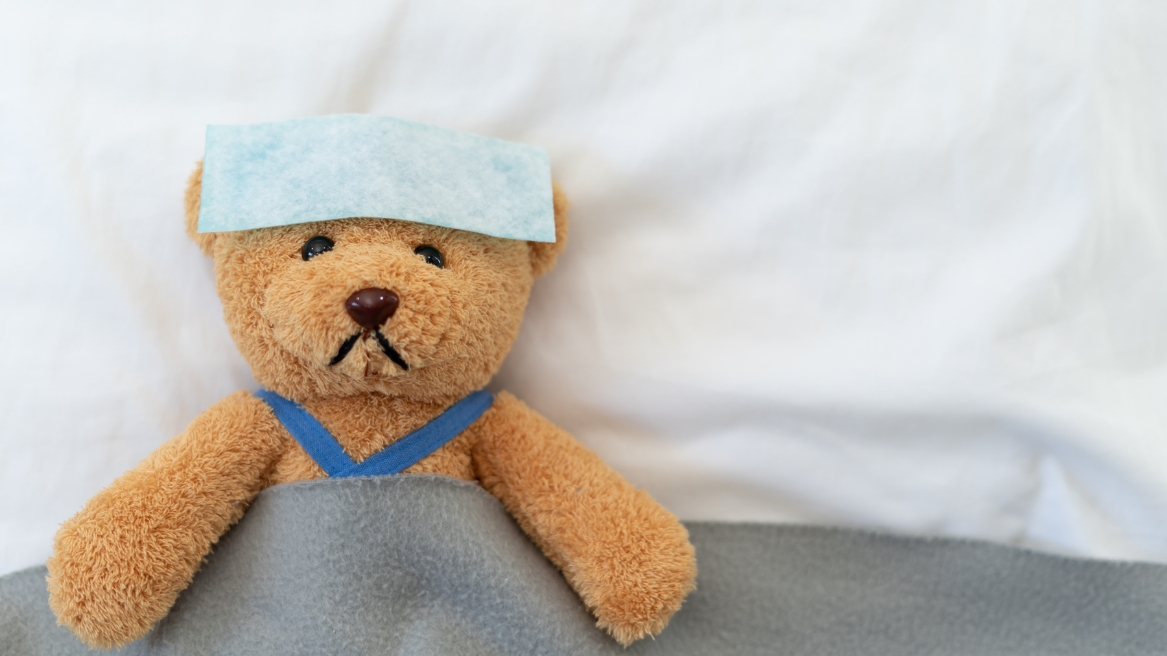 A Picture of a teddy bear who is sick of the flu.