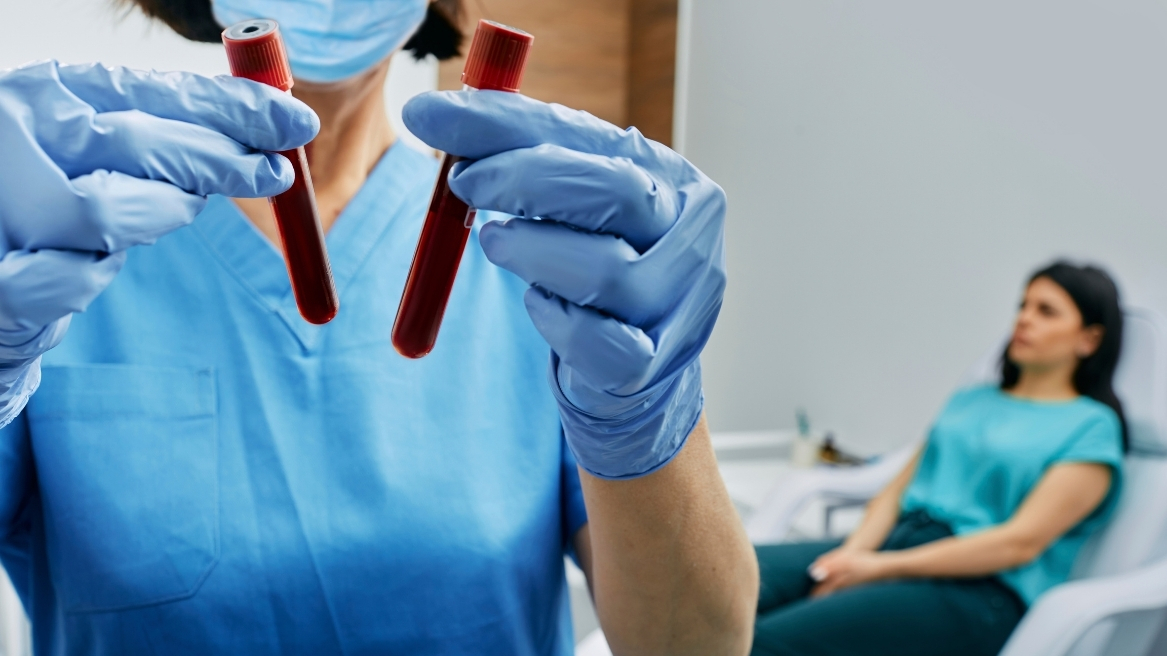 Medical professional holding blood vials for private blood testing at Hodgson Pharmacy.